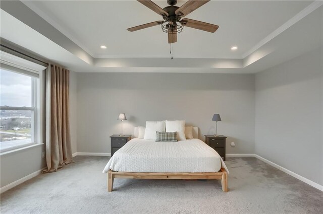 bedroom featuring a raised ceiling, recessed lighting, baseboards, and light carpet