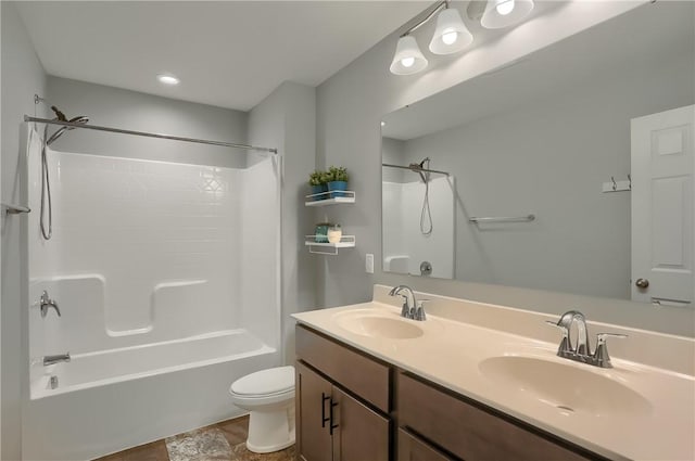 full bathroom with shower / bathing tub combination, toilet, double vanity, and a sink