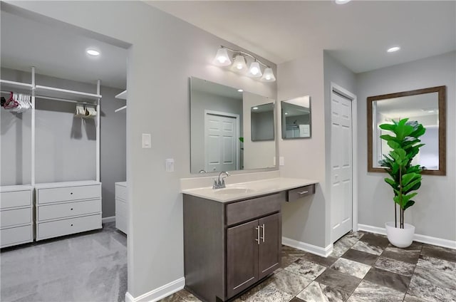 bathroom with a closet and baseboards