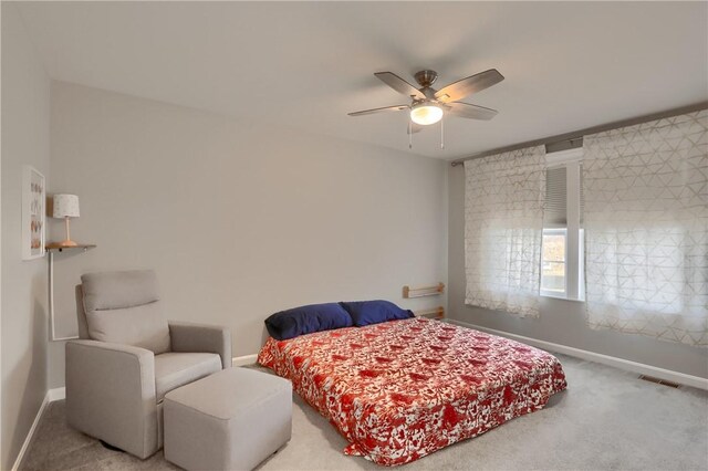 bedroom featuring visible vents, a ceiling fan, baseboards, and carpet floors