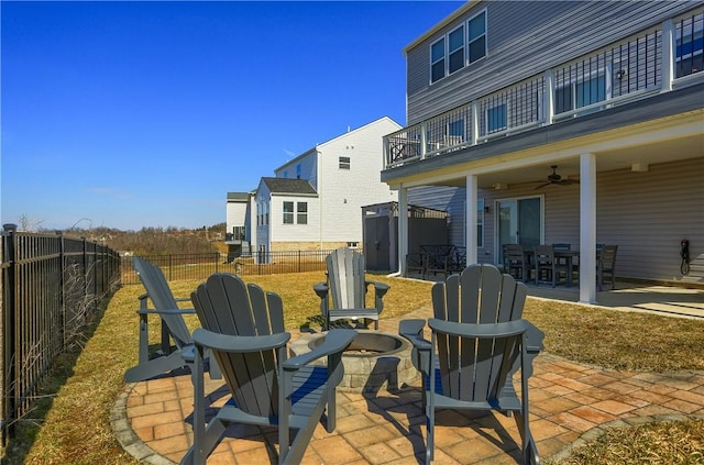 view of patio / terrace with outdoor dining space, a balcony, a ceiling fan, and a fenced backyard