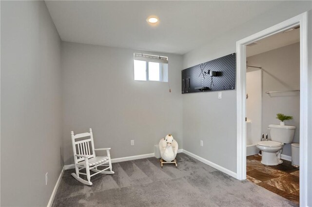 sitting room featuring carpet flooring and baseboards