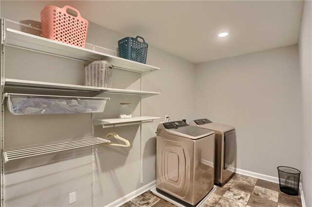 washroom featuring stone finish flooring, washing machine and dryer, recessed lighting, baseboards, and laundry area