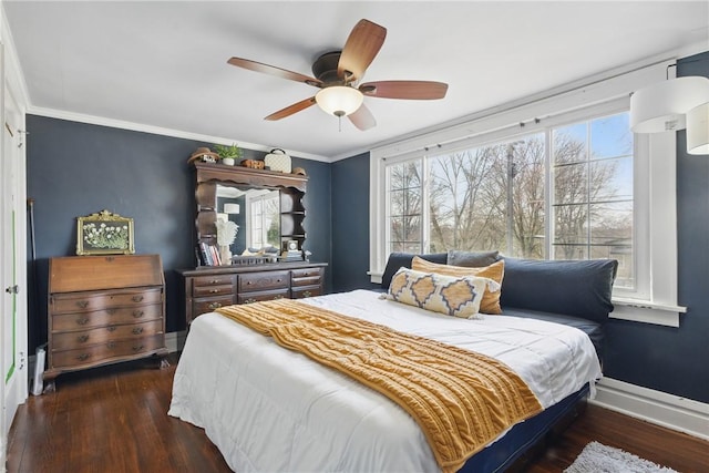 bedroom featuring crown molding, wood finished floors, baseboards, and ceiling fan