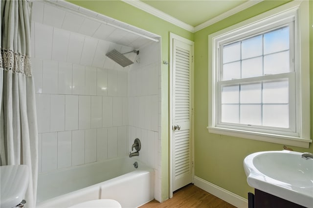 bathroom with vanity, wood finished floors, baseboards, shower / bath combo, and ornamental molding