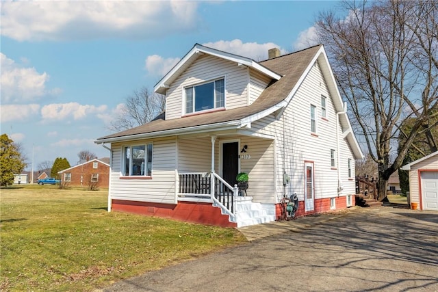 view of front facade with a chimney, covered porch, and a front yard