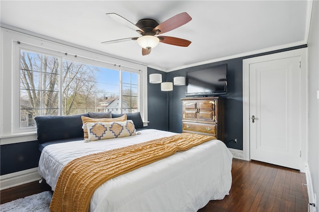 bedroom with a ceiling fan, crown molding, dark wood-style floors, and baseboards