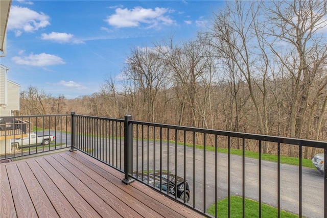 wooden terrace with a view of trees