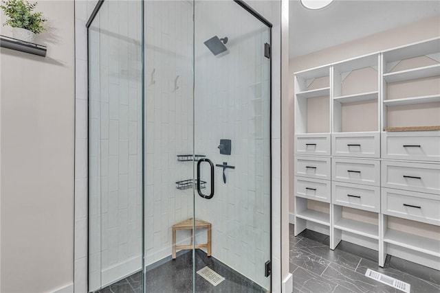 full bathroom with a stall shower and marble finish floor