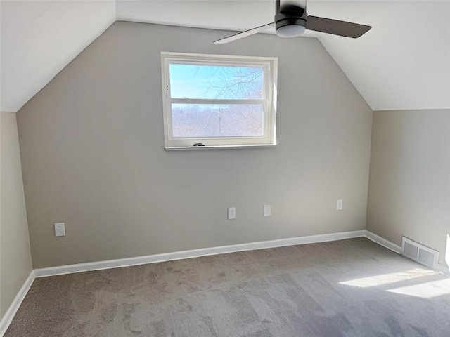 bonus room featuring lofted ceiling, carpet, visible vents, and baseboards