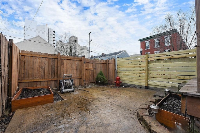 view of patio / terrace featuring a vegetable garden and a fenced backyard