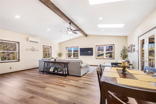 living area with recessed lighting, light wood-type flooring, lofted ceiling with skylight, and an AC wall unit