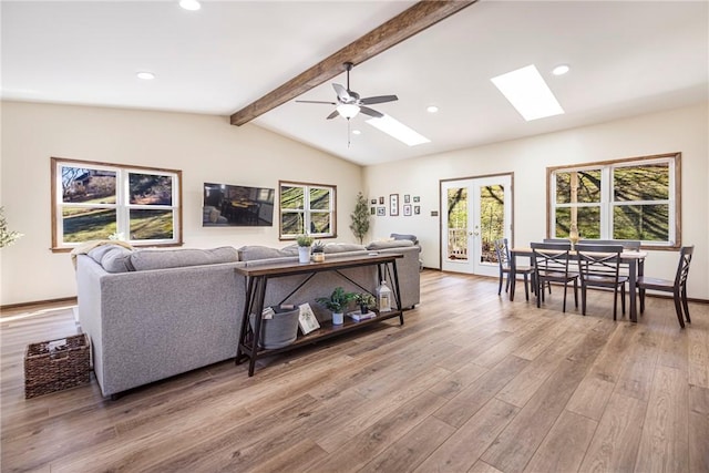 living area featuring a ceiling fan, lofted ceiling with beams, recessed lighting, french doors, and light wood-type flooring