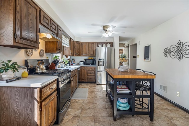 kitchen with visible vents, ceiling fan, light countertops, appliances with stainless steel finishes, and under cabinet range hood