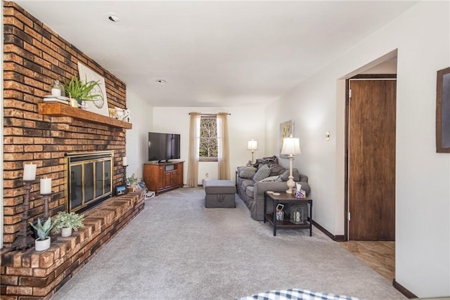 living area featuring a brick fireplace, baseboards, and carpet