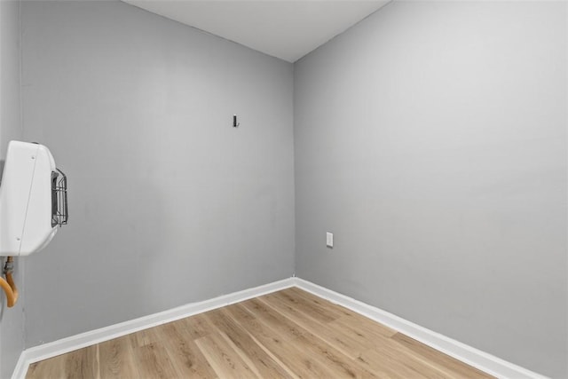 unfurnished room with light wood-style flooring and baseboards