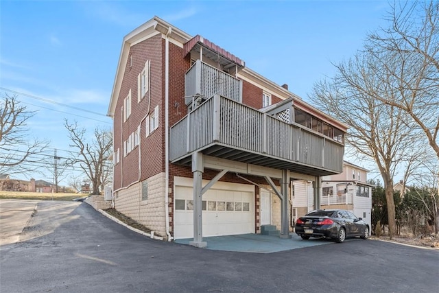 exterior space featuring brick siding and an attached garage