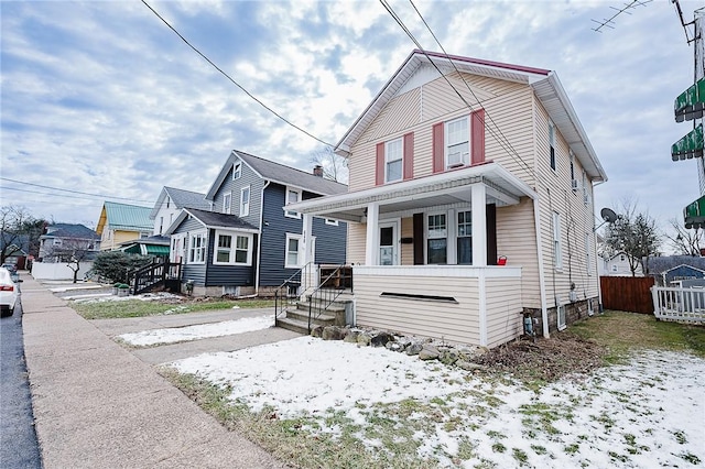 view of front of house featuring a porch and fence