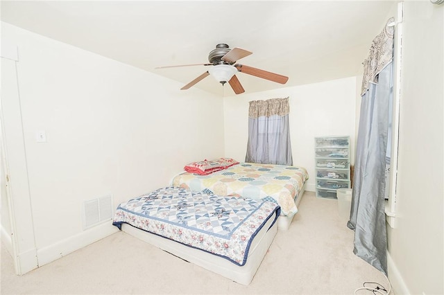 carpeted bedroom with visible vents and ceiling fan