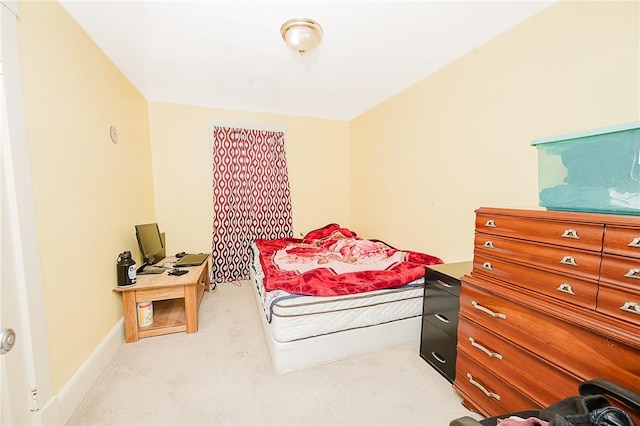 bedroom featuring carpet flooring and baseboards