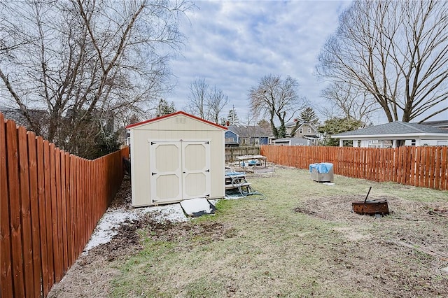 view of shed with a trampoline and a fenced backyard