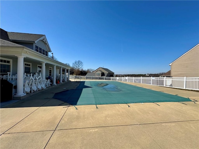 view of swimming pool featuring a patio, fence, and a fenced in pool