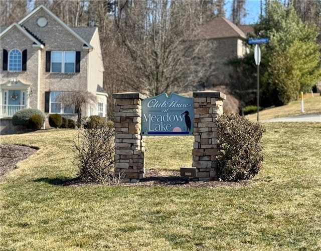 community / neighborhood sign with a lawn