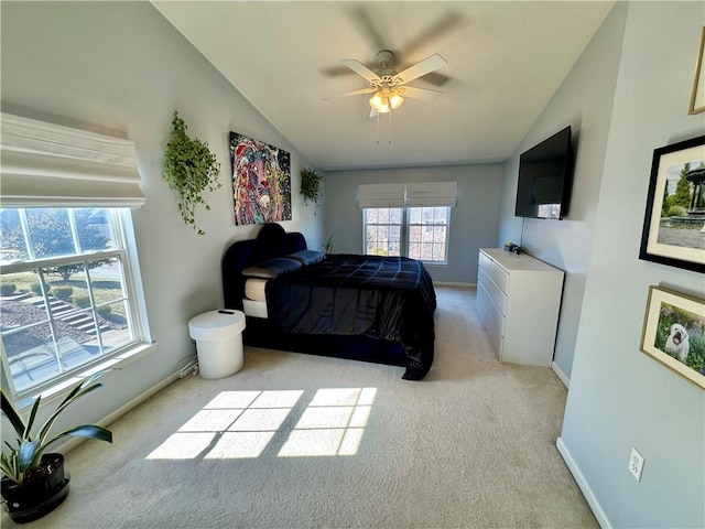 bedroom featuring vaulted ceiling, baseboards, and light carpet