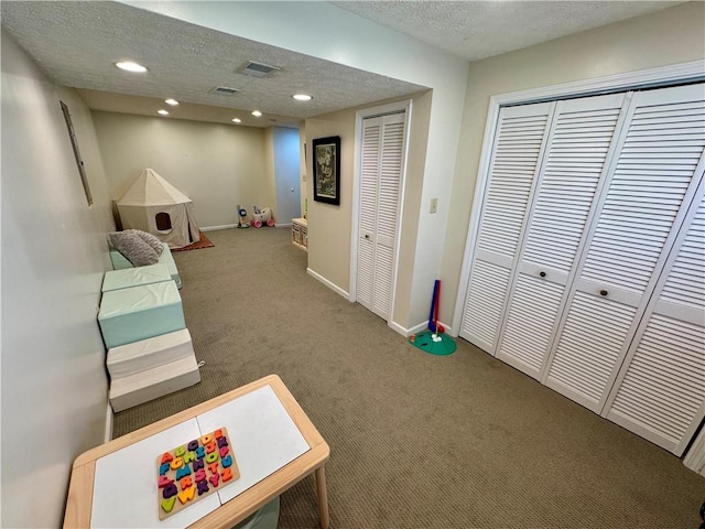 game room featuring recessed lighting, a textured ceiling, baseboards, and carpet floors