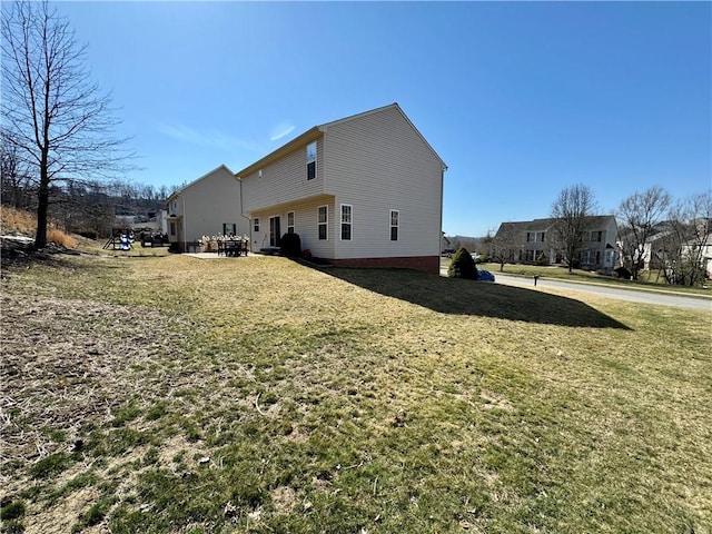 view of side of property with a lawn