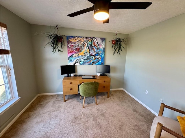 office area featuring baseboards, a textured ceiling, carpet, and a ceiling fan