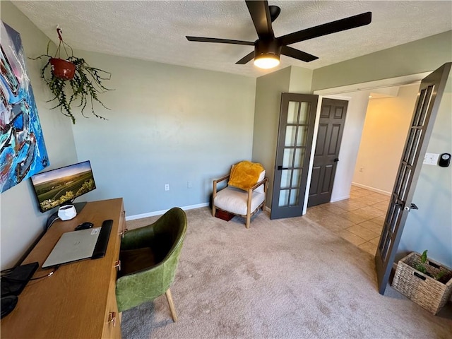 interior space featuring ceiling fan, tile patterned flooring, french doors, a textured ceiling, and carpet flooring