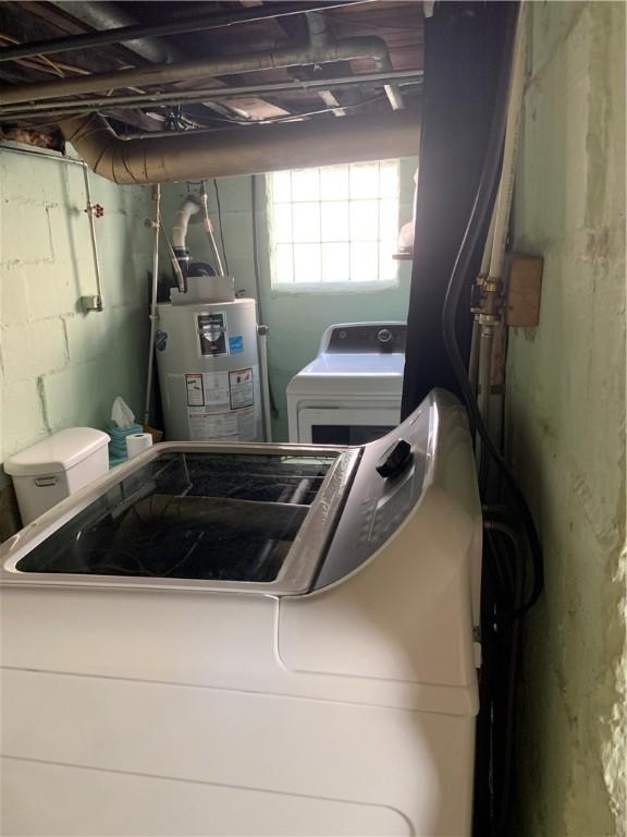 laundry area featuring washer / dryer, gas water heater, and laundry area