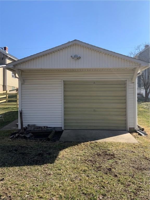 garage with driveway and fence