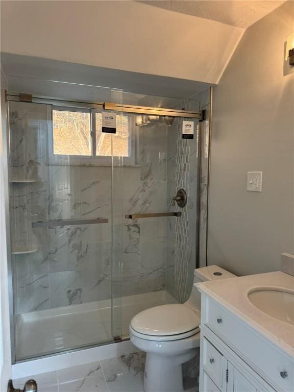 full bath with vanity, toilet, marble finish floor, and a marble finish shower