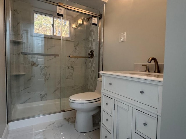 bathroom featuring a marble finish shower, marble finish floor, vanity, and toilet