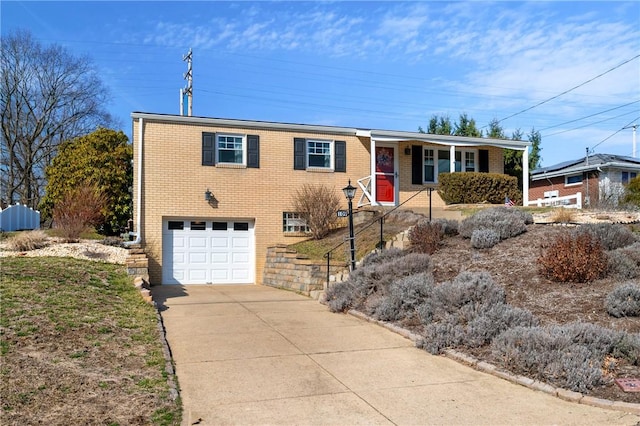 single story home featuring brick siding, driveway, and a garage