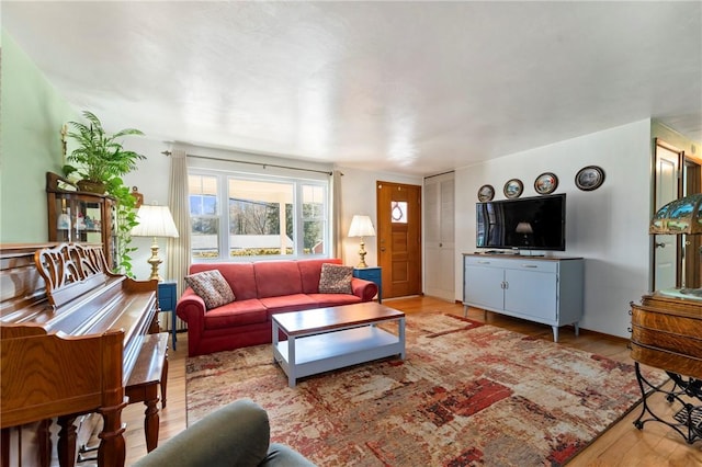 living room with baseboards and wood finished floors