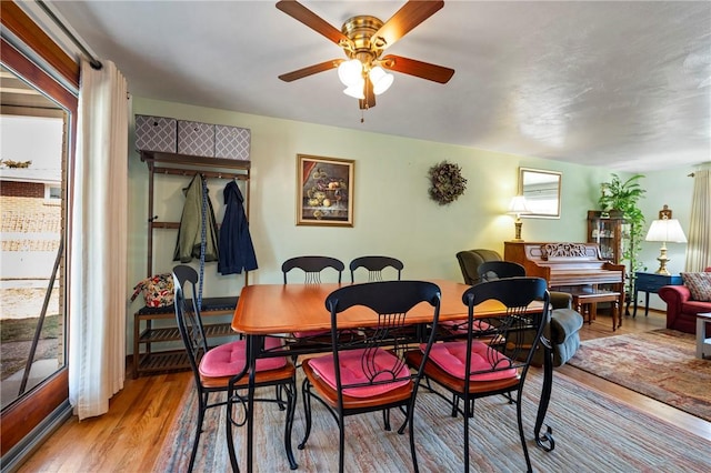 dining room with a ceiling fan and wood finished floors