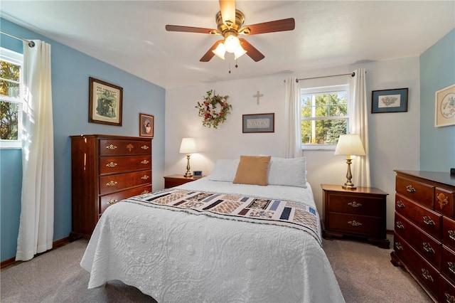 carpeted bedroom with baseboards and a ceiling fan