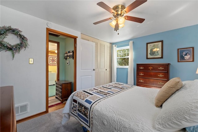 carpeted bedroom featuring a ceiling fan, baseboards, visible vents, and a closet