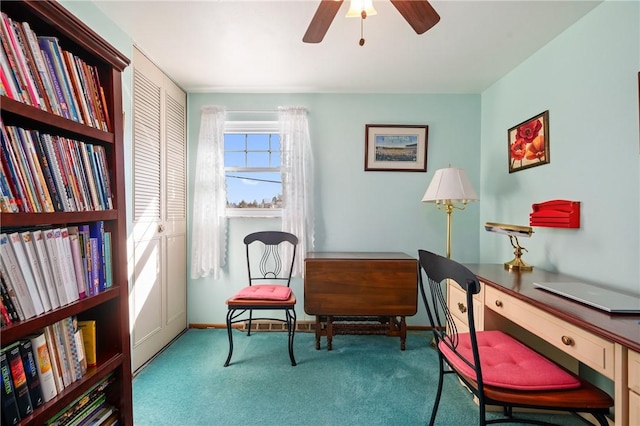 carpeted home office with baseboards and a ceiling fan