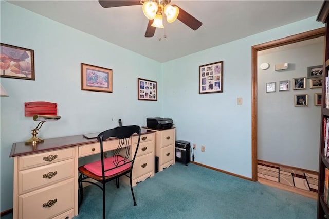 carpeted office featuring a ceiling fan and baseboards