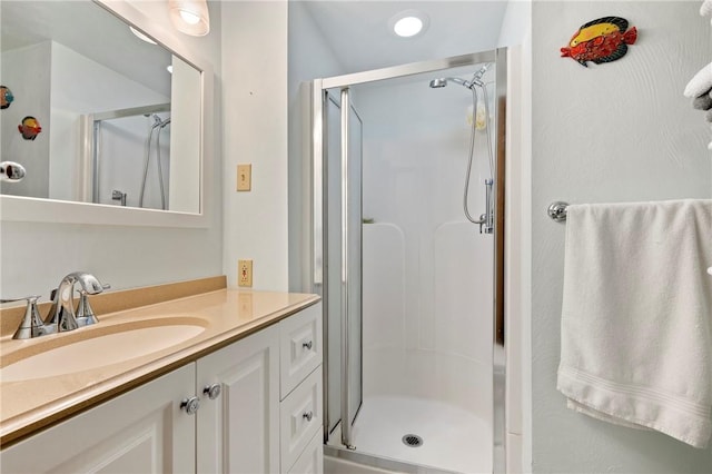 full bath featuring a stall shower and vanity