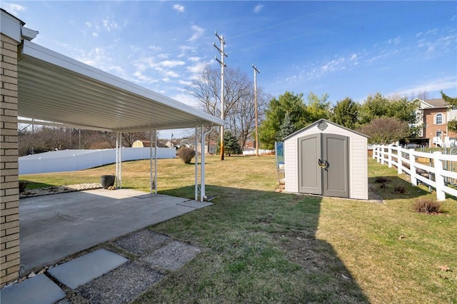 view of yard with an outdoor structure, a storage unit, a patio area, and fence