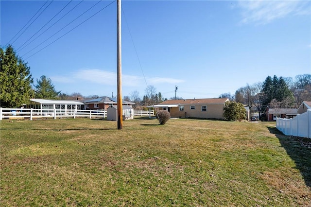 view of yard featuring an outdoor structure and fence