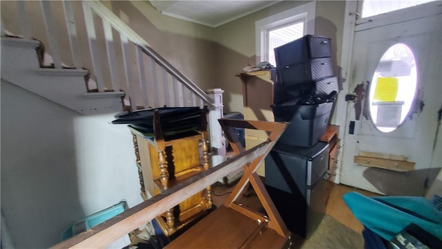 interior space with crown molding, stairway, and wood finished floors