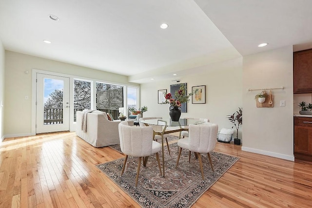 dining space with recessed lighting, light wood-style flooring, and baseboards