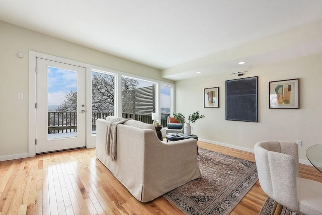 living room featuring light wood-type flooring and baseboards