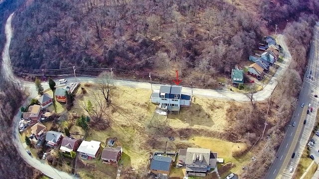 drone / aerial view with a wooded view